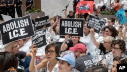 Hundreds of activists protest the Trump administration's approach to illegal border crossings and separation of children from immigrant parents, in the Hart Senate Office Building on Capitol Hill in Washington, June 28, 2018. 