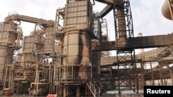 FILE - A view of a damaged production unit after a bomb attack by militants at Baiji oil refinery, 180 kilometers north of Baghdad, Iraq, Feb. 26, 2011. 