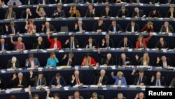 FILE - Members of the European Parliament take part in a voting session in Strasbourg, France, April 12, 2016. 