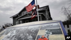 Flags fly at half-staff outside the John & Annie Glenn Museum, Dec. 9, 2016, in New Concord, Ohio. 