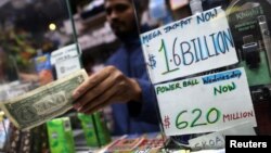 A newsstand vendor takes a customer's cash for tickets in Tuesday's Mega Millions and Wednesday's Powerball lottery drawings in New York City, New York, U.S., October 23, 2018. 