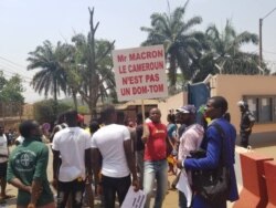 Youths protest against French President Emmanuel Macron's declarations over how Cameroon is handling the conflict in its English-speaking regions, outside the French embassy in Yaounde, Feb. 24, 2020. (Moki Edwin Kindzeka/VOA)
