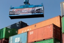 FILE - A container is loaded on to the first Chinese container ship to depart after the inauguration of the China-Pakistan Economic Corridor port in Gwadar, Pakistan, Nov. 13, 2016.