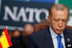 Presiden Turki Recep Tayyip Erdogan menunggu dimulainya pertemuan meja bundar KTT NATO di Vilnius, Lituania, pada 11 Juli 2023. (Foto: AP)