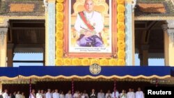 Cambodia's King Norodom Sihamoni (C) greets people from the Royal Palace during a ceremony to mark the 10th anniversary of his coronation, in Phnom Penh October 29, 2014. Cambodians marked the anniversary on Tuesday and Wednesday.