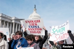 FILE - A group of Rep. George Santos's constituents from New York's 3rd Congressional District holds news conference and petition drive calling for Santos’s resignation on Capitol Hill in Washington.