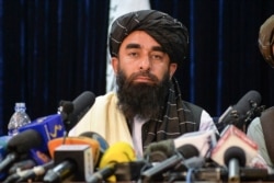 FILE - Taliban spokesperson Zabihullah Mujahid looks on as he addresses the first press conference in Kabul on Aug. 17, 2021 following the Taliban stunning takeover of Afghanistan.