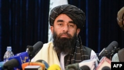 Taliban spokesperson Zabihullah Mujahid looks on as he addresses the first press conference in Kabul on Aug. 17, 2021 following the Taliban stunning takeover of Afghanistan.