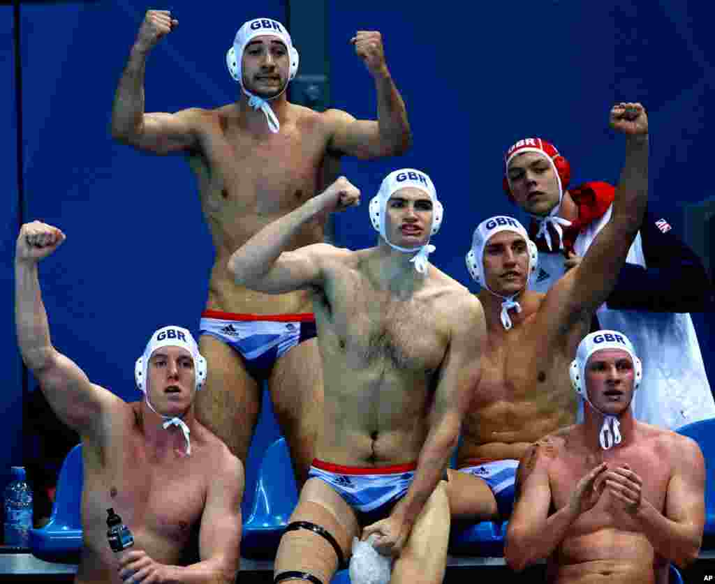 Britain's water polo players react to a goal by Glen Robinson during a preliminary men's match against Montenegro.