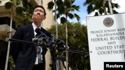 FILE - Hawaii Attorney General Douglas Chin answers questions from reporters after filing an amended lawsuit against President Donald Trump's latest travel ban in Honolulu, Hawaii, March 15, 2017.