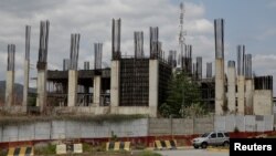 Commuters drive past the construction site by Odebrecht of the Caracas, the Guatire metro rail project in Guatire, Venezuela, March 28, 2017. Odebrecht left at least 23 multi-million dollar projects unfinished or stalled in Venezuela.