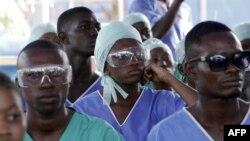 FILE - Medics listens to a speech, attend specialized training in an Ebola treatment unit in Freetown, Dec. 19, 2014
