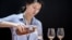 Picture taken on May 27, 2014 shows a woman pouring a glass of cognac at Vinexpo Asia Pacific in Hong Kong. 