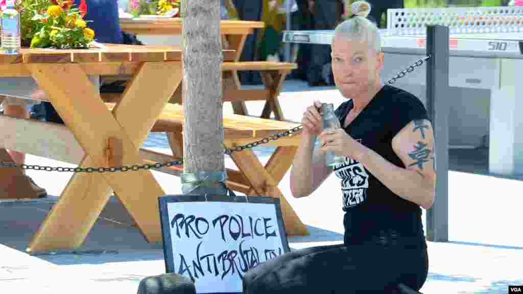 Female protester pauses for a sip of water outside the Republican National Convention in Cleveland (July 19, 2016).