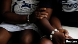 Same-sex couple, Naa Shika, 37, and her partner Kay, 27, sit together in Accra, Ghana. Jan. 23, 2024.