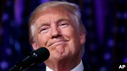 FILE - Then-President-elect Donald Trump smiles as he arrives to speak at an election night rally, Nov. 9, 2016, in New York. Trump lost the popular vote in the 2016 presidential election yet prevailed by winning in the Electoral College.