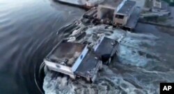 n this image taken from video released by the Ukrainian Presidential Office, water runs through a breakthrough in the Kakhovka dam in Kakhovka, Ukraine, Tuesday, June 6, 2023.