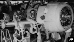 A crew of women work on the final assembly of a bomber in Tennessee on Aug. 31, 1942