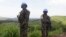 FILE - UN peacekeepers from Tanzania hold their weapons as they patrol outside Goma.