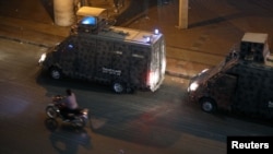 Police vehicles are seen in central Cairo as protesters gather, shouting anti-government slogans, Sept. 21, 2019.