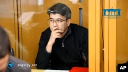In this photo released by the Kazakhstan Supreme Court Press Office’s Telegram channel on April 12, 2024, businessman Kuandyk Bishimbayev, the country’s former economy minister, sits in a defendants’ cage at his trial in Astana, Kazakhstan.