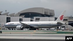 FILE - An Air China plane is parked at a gate at Los Angeles International Airport, in Los Angeles, California, May 9, 2019.