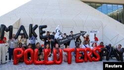 Activists protest during COP28 in Dubai, United Arab Emirates, Dec. 10, 2023. Taiwan, with per capita emissions among the highest in the world, is blocked from participating in the summit. However, a Taiwanese official says Taiwan is willing to donate to a climate damage fund.