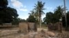FILE - Burned-out huts are seen at the scene of an armed attack in Chitolo village, Mozambique, July 10, 2018. 