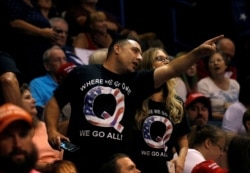 FILE - Supporters wearing shirts with the QAnon logo are seen at a Trump rally in Wilkes-Barre, Pennsylvania, Aug. 2, 2018.