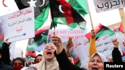 FILE - Libyan women chant slogans during a demonstration to demand an end to the Khalifa Haftar's offensive against Tripoli, in Martyrs' Square in central Tripoli, Libya, April 26, 2019.