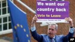 FILE - Nigel Farage, a British politician and leader of the UKIP party, holds up a placard as he launches his party's campaign for Britain to leave the European Union, outside the EU representative office in London, May, 20, 2016.
