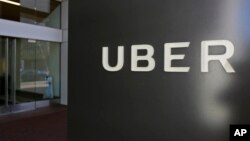 FILE - This March 1, 2017, file photo shows an exterior view of the headquarters of Uber in San Francisco. Toyota will sink a half-billion dollars into Uber and work jointly with the ride-hailing giant to develop self-driving vehicles. 