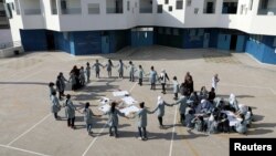 FILE - Palestinian children take part in an activity at a school run by United Nations Relief and Works Agency in the Shuafat refugee camp in East Jerusalem October 10, 2018.
