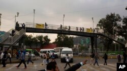 A man jokes with a friend as he sings near a subway station, during the coronavirus pandemic in Mexico City, June 1, 2020. 