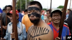 FILE - A group of Ache indigenous men block a highway in Asuncion, Paraguay, March 31, 2011, demanding the government return their ancestral lands, over 11,000 acres, near the Mbaracayu Forest Nature Reserve.