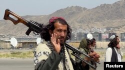 Taliban forces patrol at a runway a day after U.S. troops' withdrawal from Hamid Karzai International Airport in Kabul, Afghanistan, August 31, 2021. 