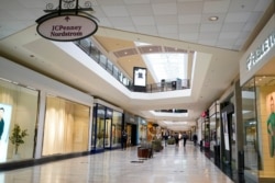 FILE - In this photo made on Feb. 24, 2021, people walks through a shopping mall in Pittsburgh.