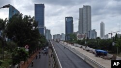 FILE - In this Jan. 11, 2013 photo, workers build an elevated highway in Jakarta, Indonesia. (AP Photo/Achmad Ibrahim)