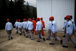 Staff members walk at Xichang Satellite Launch Center, the day before the Beidou-3 satellite, the last satellite of China's Beidou Navigation Satellite System, was set to launch, in Sichuan province, China, June 15, 2020.