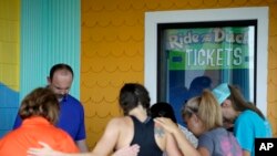 People gather outside Ride the Ducks, an amphibious tour operator involved in an accident on Table Rock Lake, July 20, 2018 in Branson, Missouri.