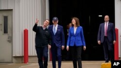 President Joe Biden and Rep. Cindy Axne, D-Iowa, right, listen as Jack Mitchell, regional vice president of POET Bioprocessing, during a tour at POET Bioprocessing in Menlo, Iowa, April 12, 2022.