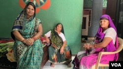 Manju Chhoker (left) says stoves lit with firewood cause health problems for village residents. (Anjana Pasricha)