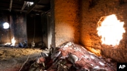 FILE - Scattered grain sits inside a warehouse damaged by Russian attacks in Cherkaska Lozova, on the outskirts of Kharkiv, Ukraine, May 28, 2022. Russia and Turkey voiced support this week for creation of a safe maritime corridor in the Black Sea so Ukraine can export grain, but Russia demanded that the Black Sea be demined and Turkey said allowing the Ukraine exports should be accompanied by easing Western sanctions against Russia.