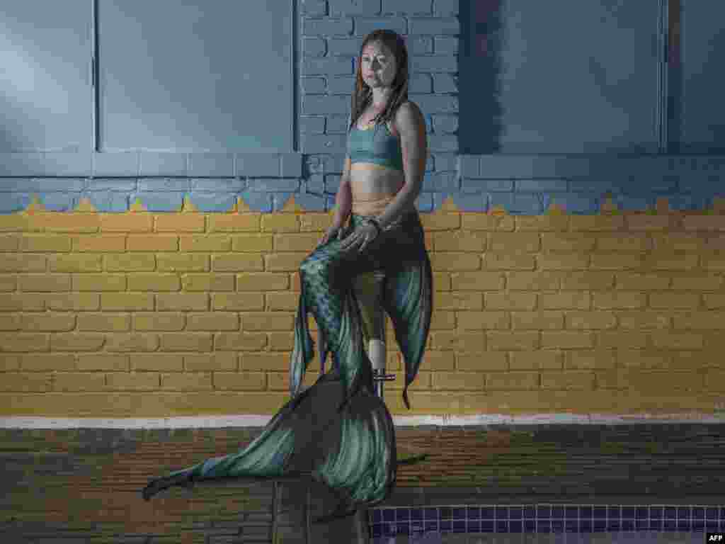 Izelle Nair, 39, the instructor at the Merschool, poses for a portrait in her mermaid attire at the center in Kayalami, Midrand. Mermaiding is a fast-growing sport world wide, and includes several skills such as monofin swimming, sculling, and breath hold.