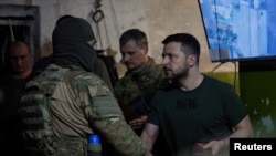 Ukraine's President Volodymyr Zelenskiy honors a soldier as he visits a position of Ukrainian service members, while Russia's attack on Ukraine continues, in Lysychansk, Luhansk region, Ukraine June 5, 2022. (Ukrainian Presidential Press Service/Handout via Reuters)