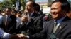 Opposition leader of Cambodia National Rescue Party Sam Rainsy, center, delivers a speech next to his Deputy President Kem Sokha, right, during a gathering to mark Human Rights Day, in front of National Assembly, in Phnom Penh, Cambodia, file photo. 