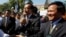 Opposition leader of Cambodia National Rescue Party Sam Rainsy, center, delivers a speech next to his Deputy President Kem Sokha, right, during a gathering to mark Human Rights Day, in front of National Assembly, in Phnom Penh, file photo. 