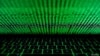 FILE - This photo illustration shows a computer keyboard lit by displayed cyber code.
