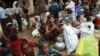 FILE - People from a Rohingya internally displaced persons (IDP) camp wait for a vehicle to return to their camp after waiting out cyclone Mahasen in a mosque outside Sittwe.
