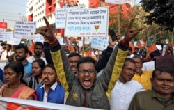 Supporters of India's ruling Bharatiya Janata Party shout slogans during a rally in support of a new citizenship law, in Kolkata, India, Feb. 4, 2020.
